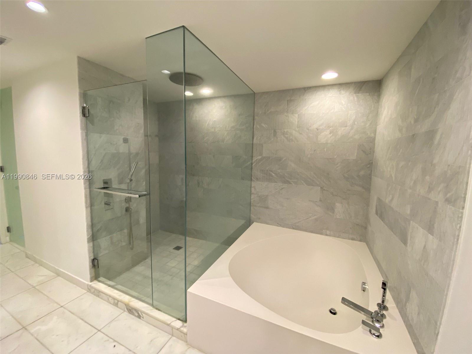 10203 Collins Avenue, Unit 905 Bal Harbour, FL 33154 - Photo 12 of 35 a bathroom with a bathtub and shower