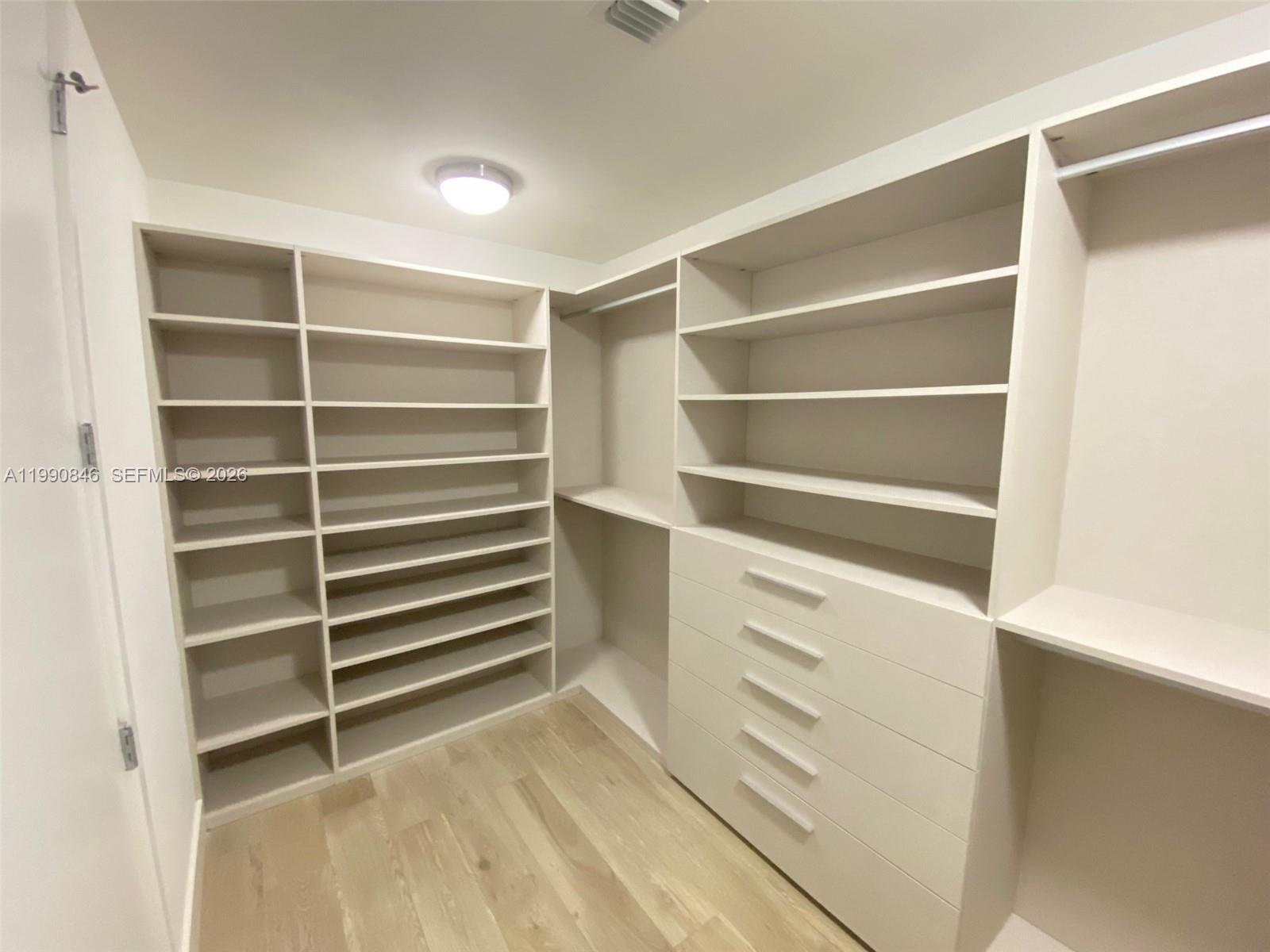 10203 Collins Avenue, Unit 905 Bal Harbour, FL 33154 - Photo 13 of 35 a view of walk in closet with empty racks
