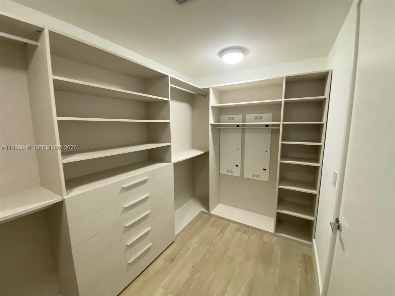 10203 Collins Avenue, Unit 905 Bal Harbour, FL 33154 - Photo 14 of 35 a view of walk in closet with empty racks