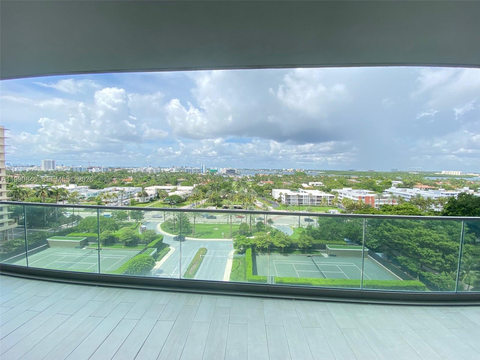 10203 Collins Avenue, Unit 905 Bal Harbour, FL 33154 - Photo 19 of 35 a view of a lake from a balcony