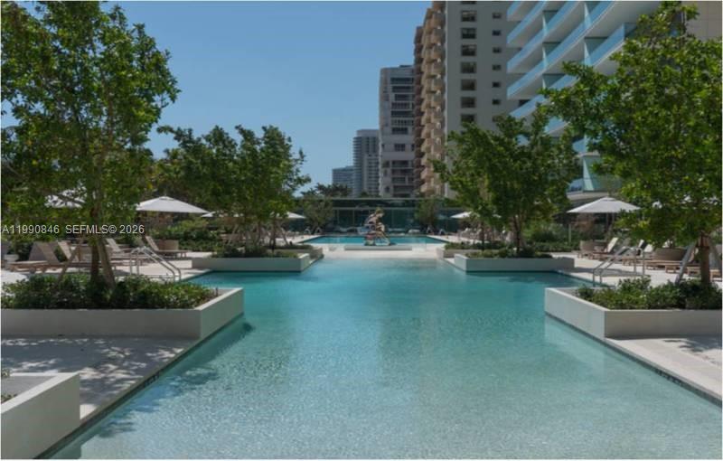 10203 Collins Avenue, Unit 905 Bal Harbour, FL 33154 - Photo 27 of 35 a view of a street with cars and trees