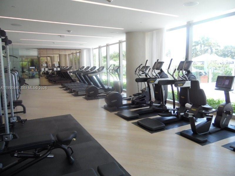 10203 Collins Avenue, Unit 905 Bal Harbour, FL 33154 - Photo 28 of 35 a view of a room with gym equipment