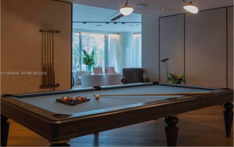 10203 Collins Avenue, Unit 905 Bal Harbour, FL 33154 - Photo 30 of 35 a living room with a table and potted plants