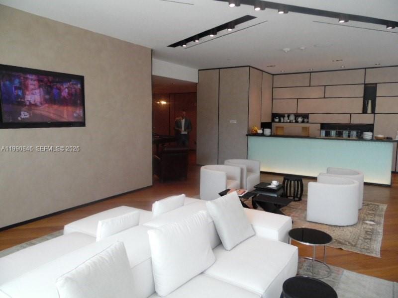 10203 Collins Avenue, Unit 905 Bal Harbour, FL 33154 - Photo 31 of 35 a bedroom with a bed and a chair