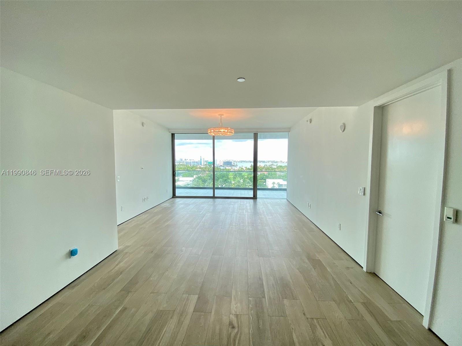 10203 Collins Avenue, Unit 905 Bal Harbour, FL 33154 - Photo 4 of 35 wooden floor in an empty room with a window