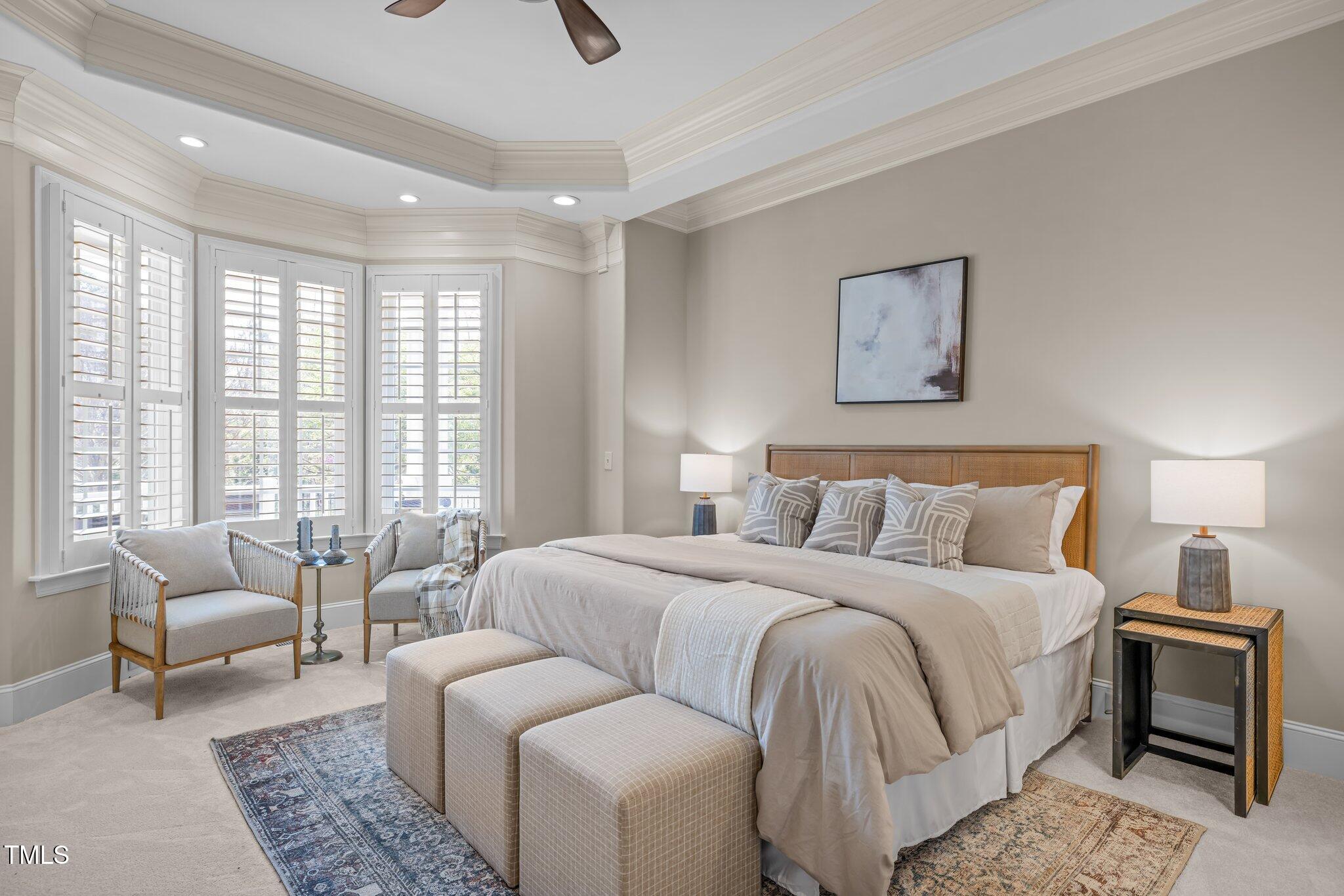 1086 Tender Drive Apex, NC 27502 - Photo 13 of 35 a bedroom with a large bed and a couch