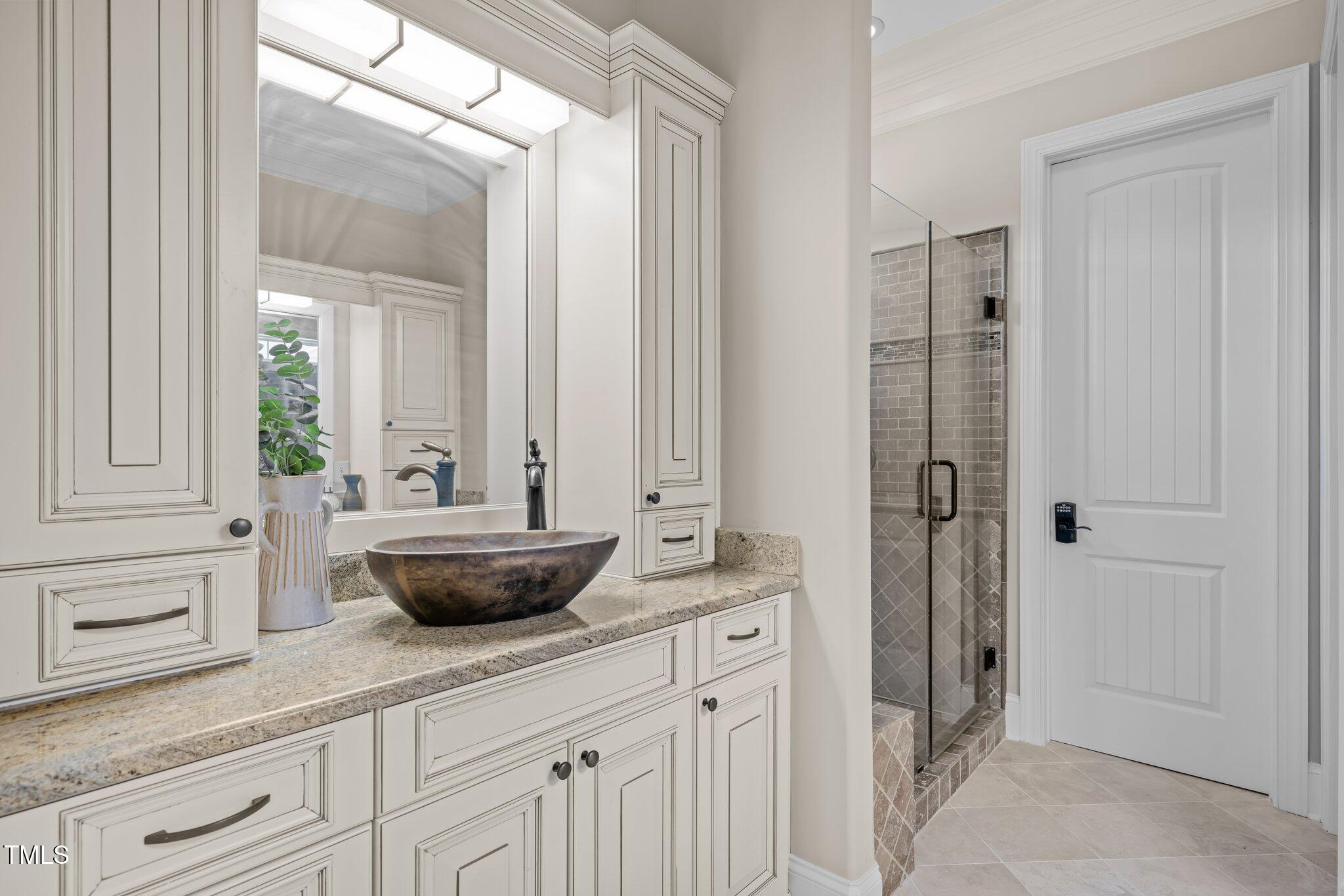 1086 Tender Drive Apex, NC 27502 - Photo 14 of 35 a bathroom with a granite countertop sink and a mirror