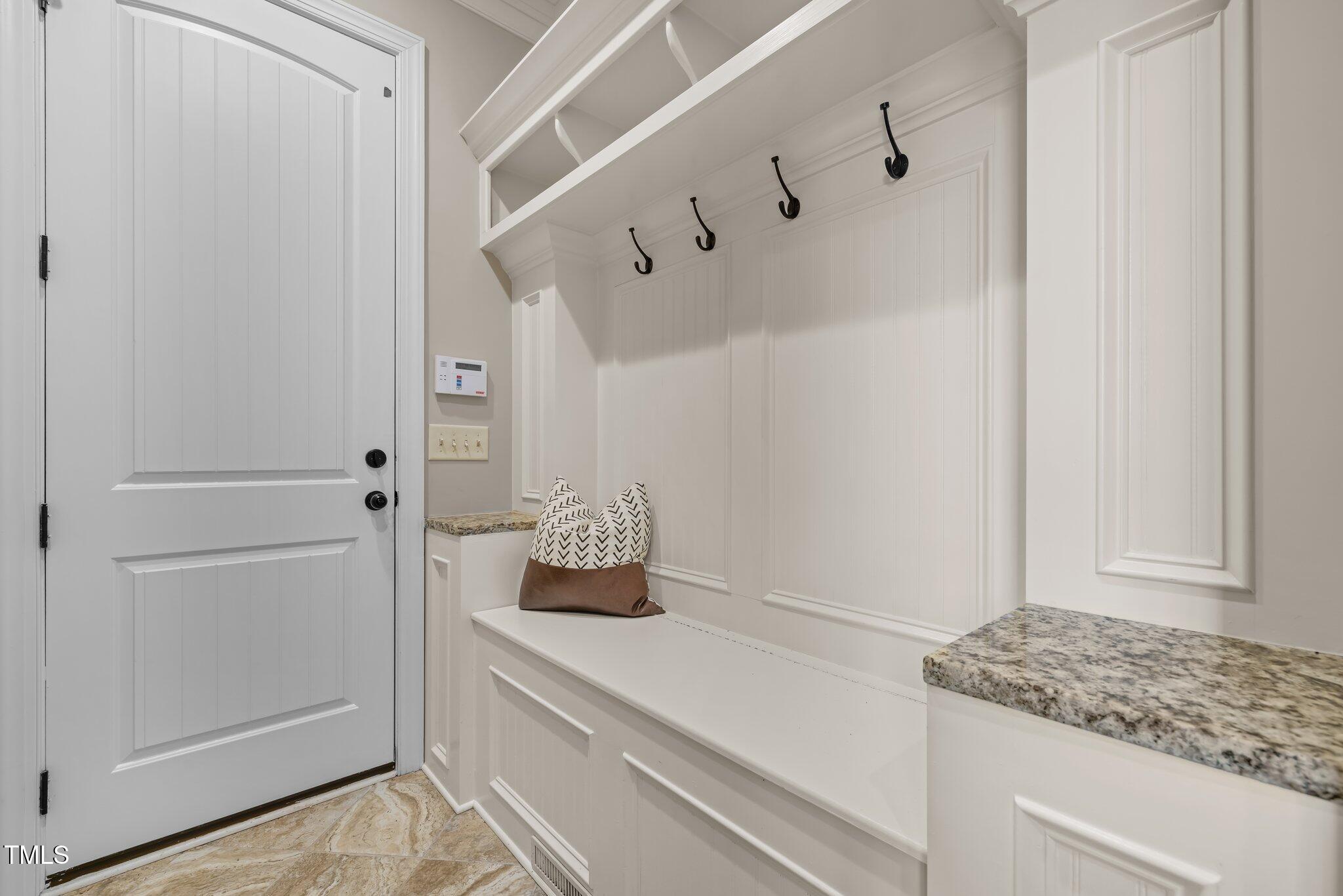 1086 Tender Drive Apex, NC 27502 - Photo 16 of 35 a bathroom with a granite countertop sink and white cabinets