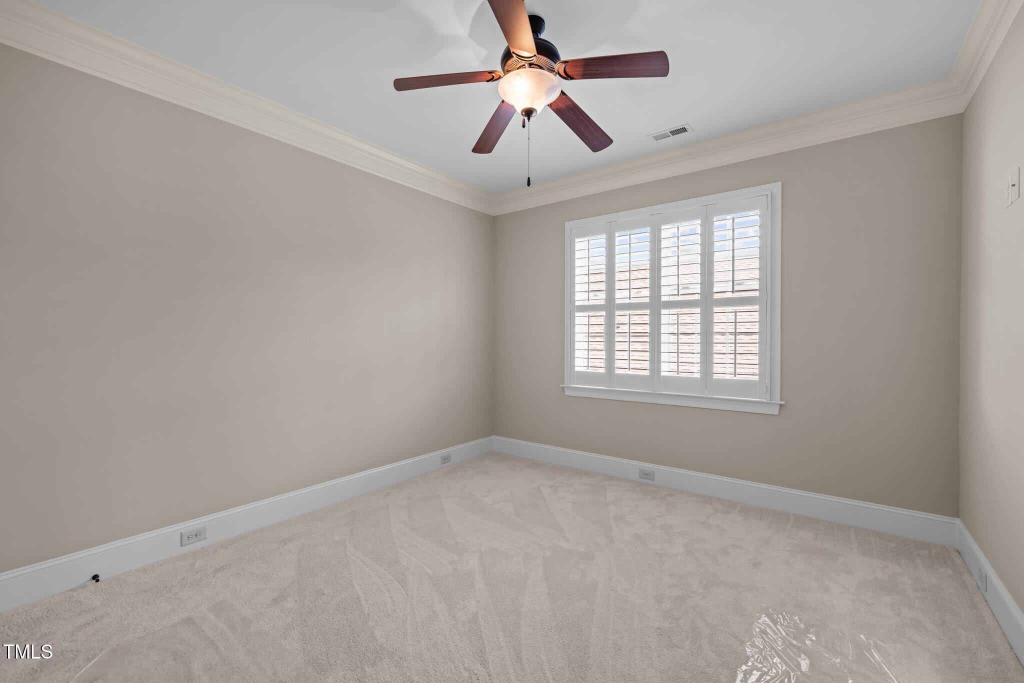 1086 Tender Drive Apex, NC 27502 - Photo 25 of 35 a view of a room with windows and ceiling fan