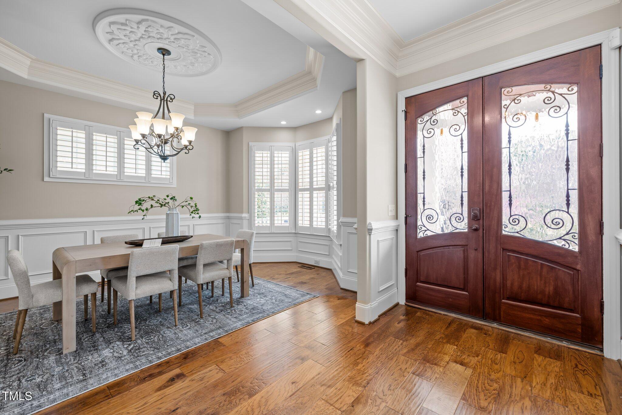 1086 Tender Drive Apex, NC 27502 - Photo 3 of 35 a view of a dining room with furniture window and wooden floor