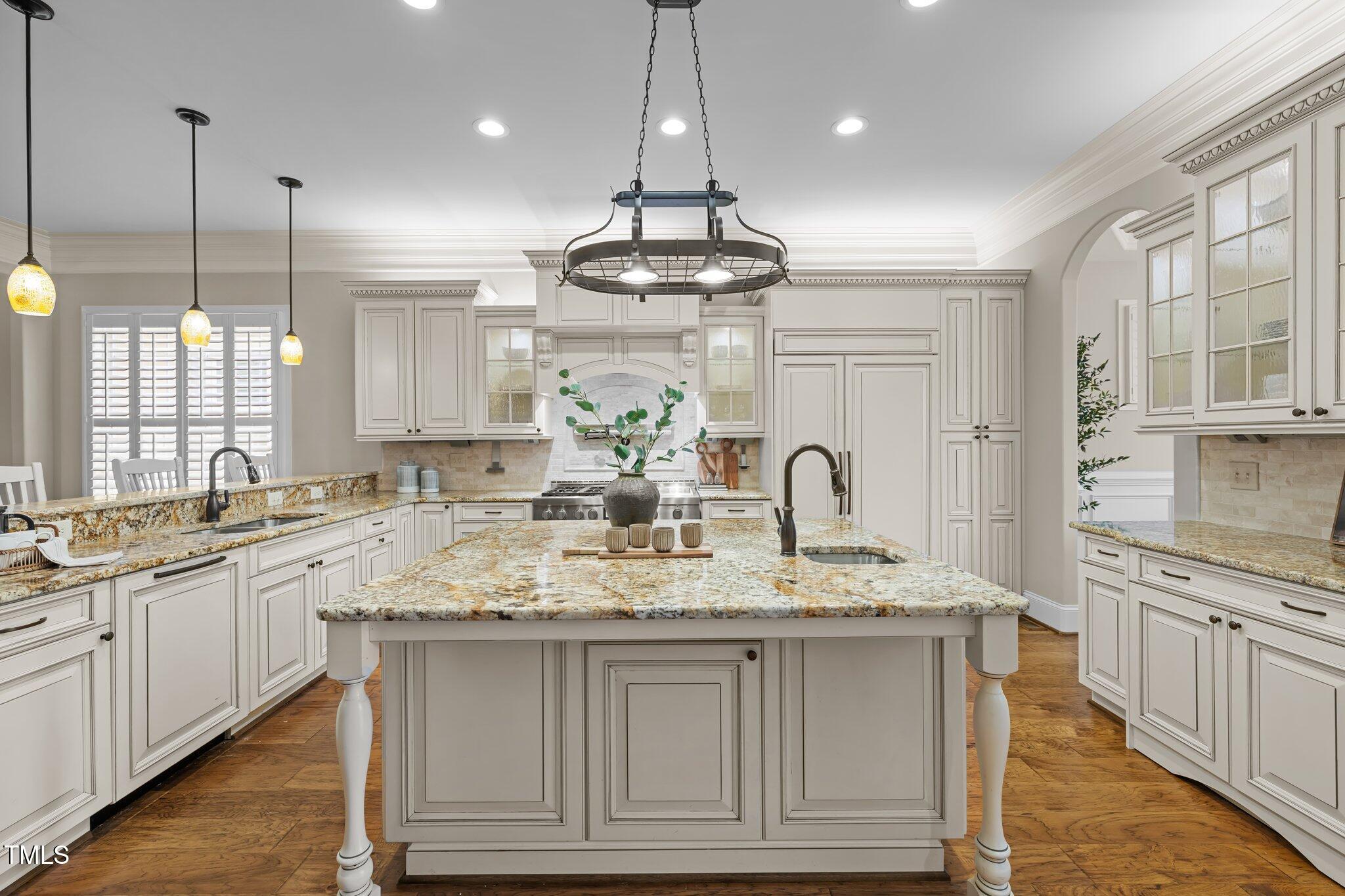 1086 Tender Drive Apex, NC 27502 - Photo 6 of 35 a kitchen with kitchen island granite countertop stainless steel appliances a sink and a wooden floors