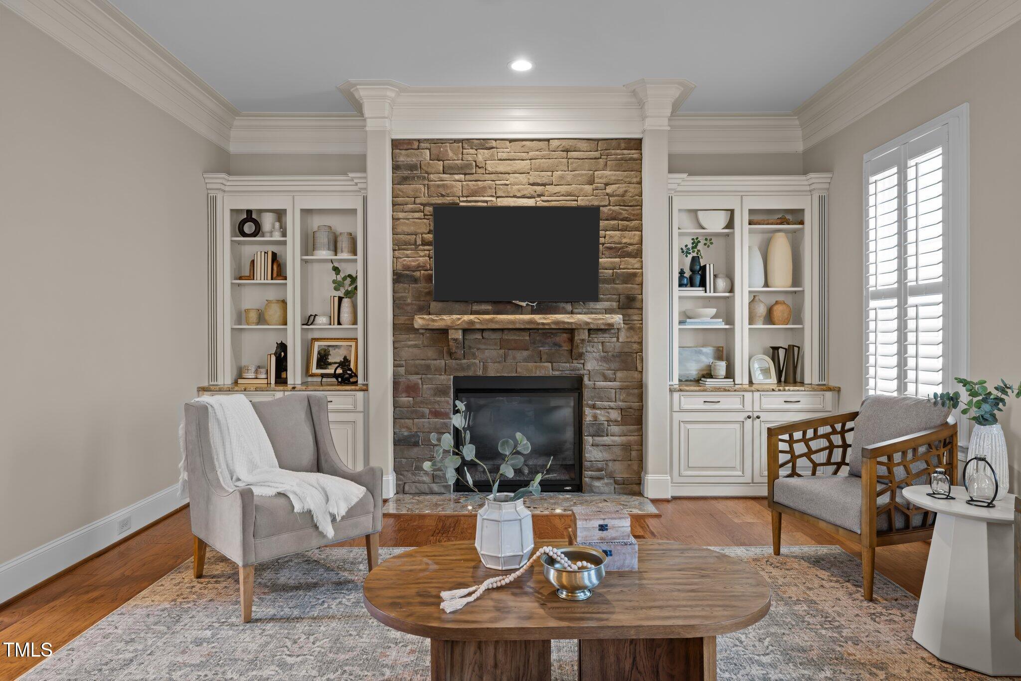 1086 Tender Drive Apex, NC 27502 - Photo 8 of 35 a living room with furniture a flat screen tv and a fireplace