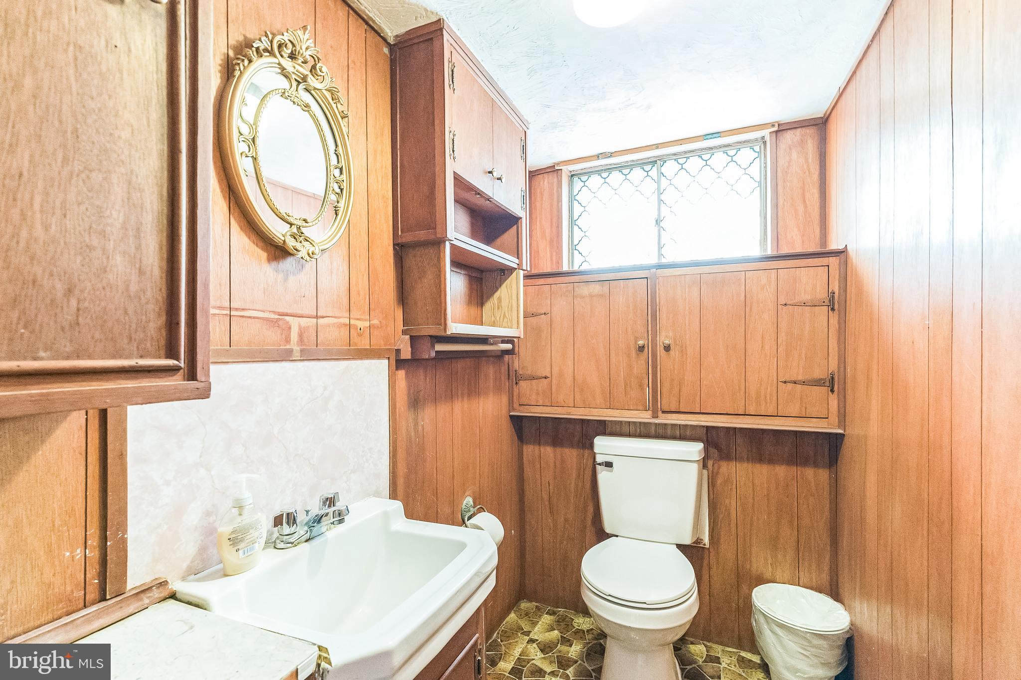 133 Lewis Road Havertown, PA 19083 - Photo 18 of 33 a white toilet sitting next to a bathroom sink and a window