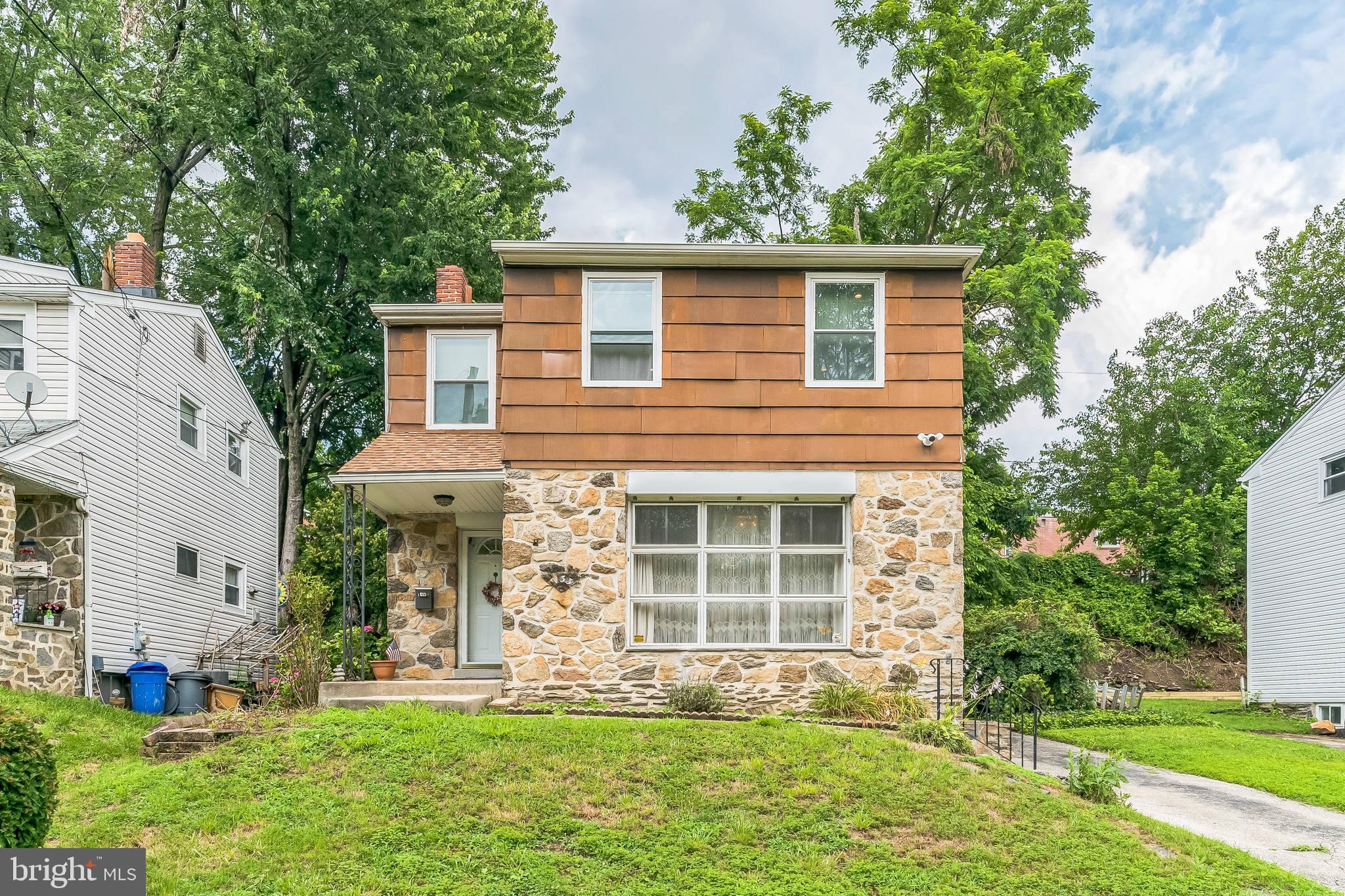 133 Lewis Road Havertown, PA 19083 - Photo 2 of 33 a front view of a house with a yard and garage
