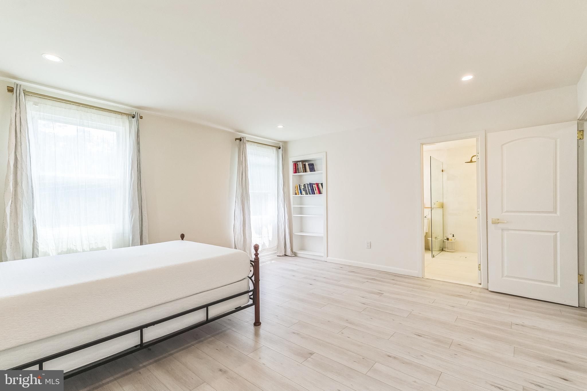 133 Lewis Road Havertown, PA 19083 - Photo 21 of 33 a bedroom with a large bed and wooden floor