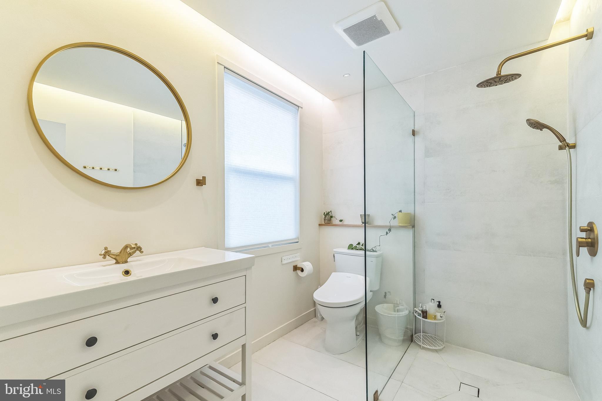 133 Lewis Road Havertown, PA 19083 - Photo 22 of 33 a bathroom with a toilet a sink and mirror
