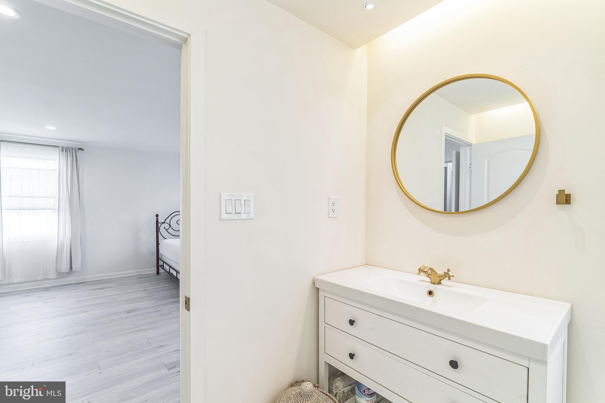 133 Lewis Road Havertown, PA 19083 - Photo 23 of 33 a bathroom with a sink mirror and vanity