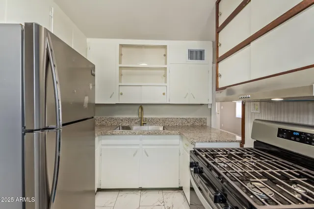 a kitchen with a stove and a refrigerator