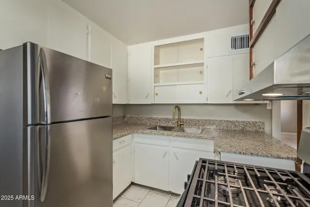 a kitchen with a refrigerator and a stove