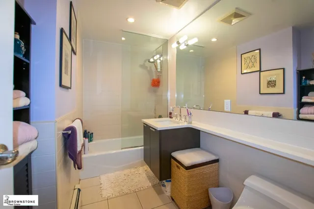 a bathroom with a sink a toilet a mirror and vanity