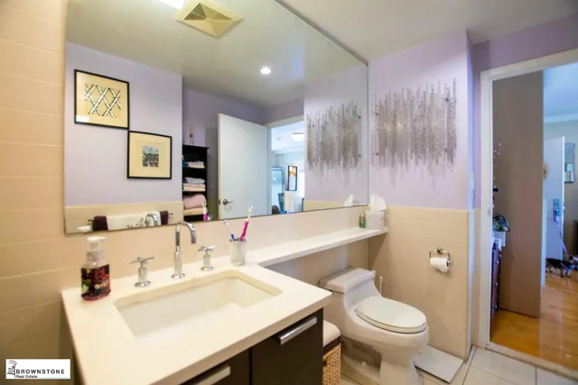 a bathroom with a sink toilet and a mirror