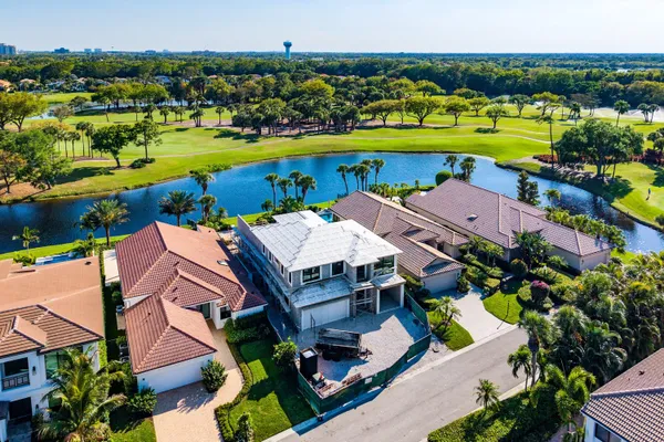 an aerial view of a house with a swimming pool yard and outdoor seating