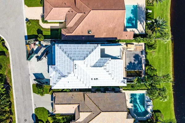an aerial view of a house with a yard