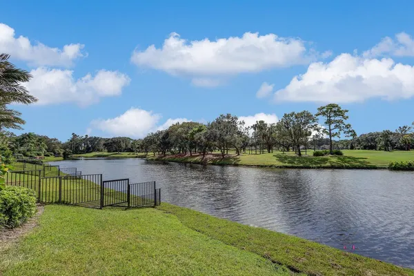 a view of a lake with houses in the back