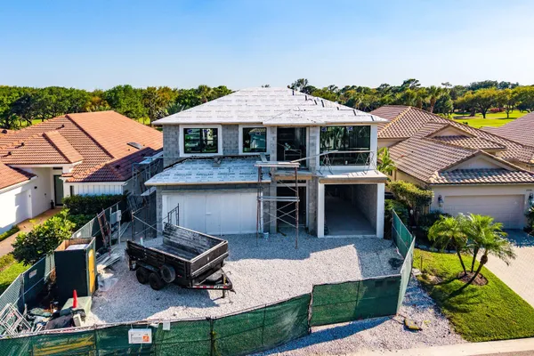 an aerial view of a house with swimming pool and furniture