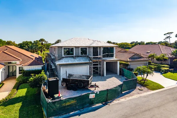 an aerial view of a house with swimming pool garden view and a chairs