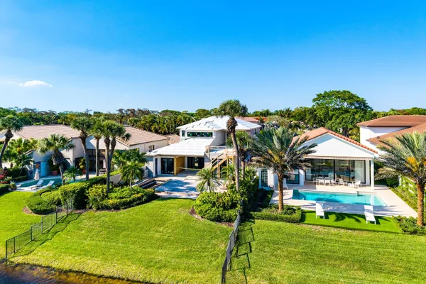 a view of a house with swimming pool and yard