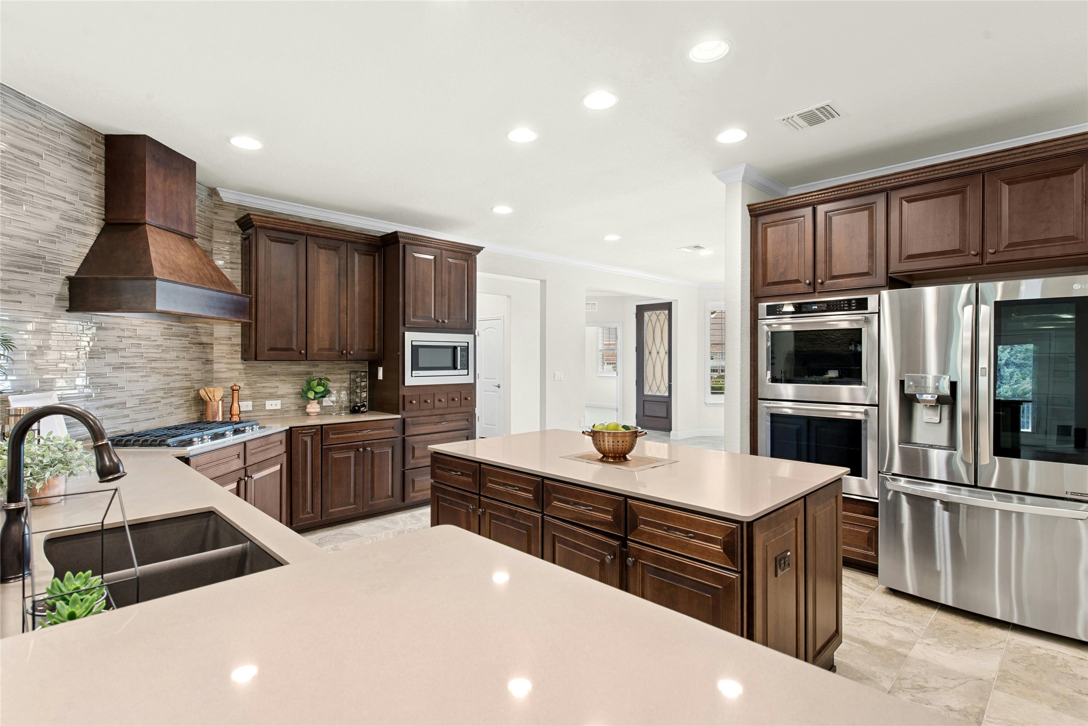105 Marfa Cove Georgetown, TX 78633 - Photo 9 of 36 a kitchen with stainless steel appliances a sink dishwasher stove refrigerator and cabinets