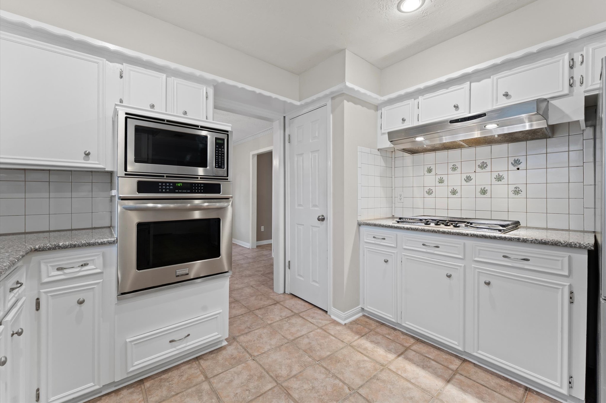 19415 Craigchester Lane Spring, TX 77388 - Photo 12 of 31 a kitchen with white cabinets stainless steel appliances and sink