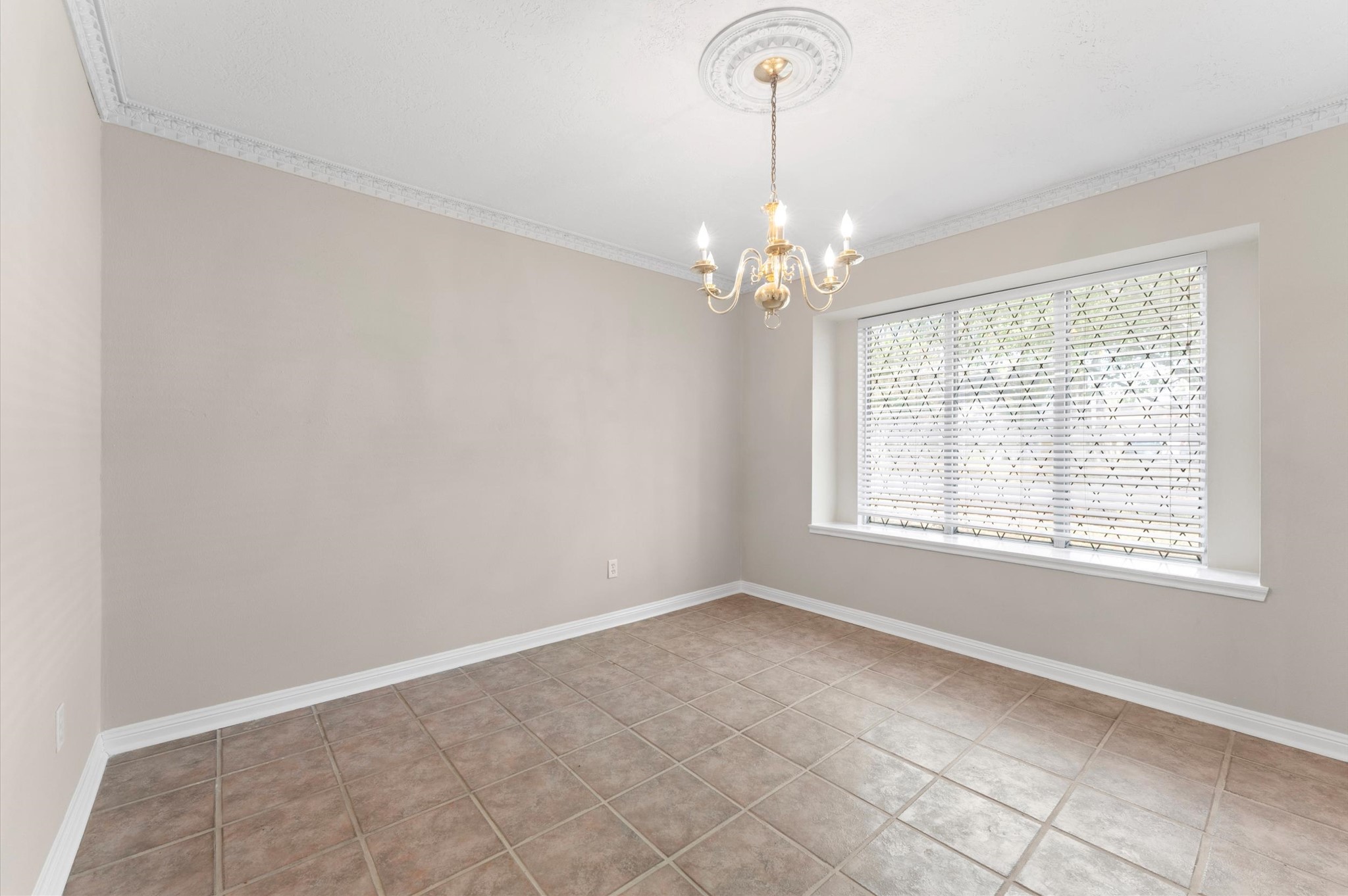 19415 Craigchester Lane Spring, TX 77388 - Photo 13 of 31 an empty room with chandelier fan and windows