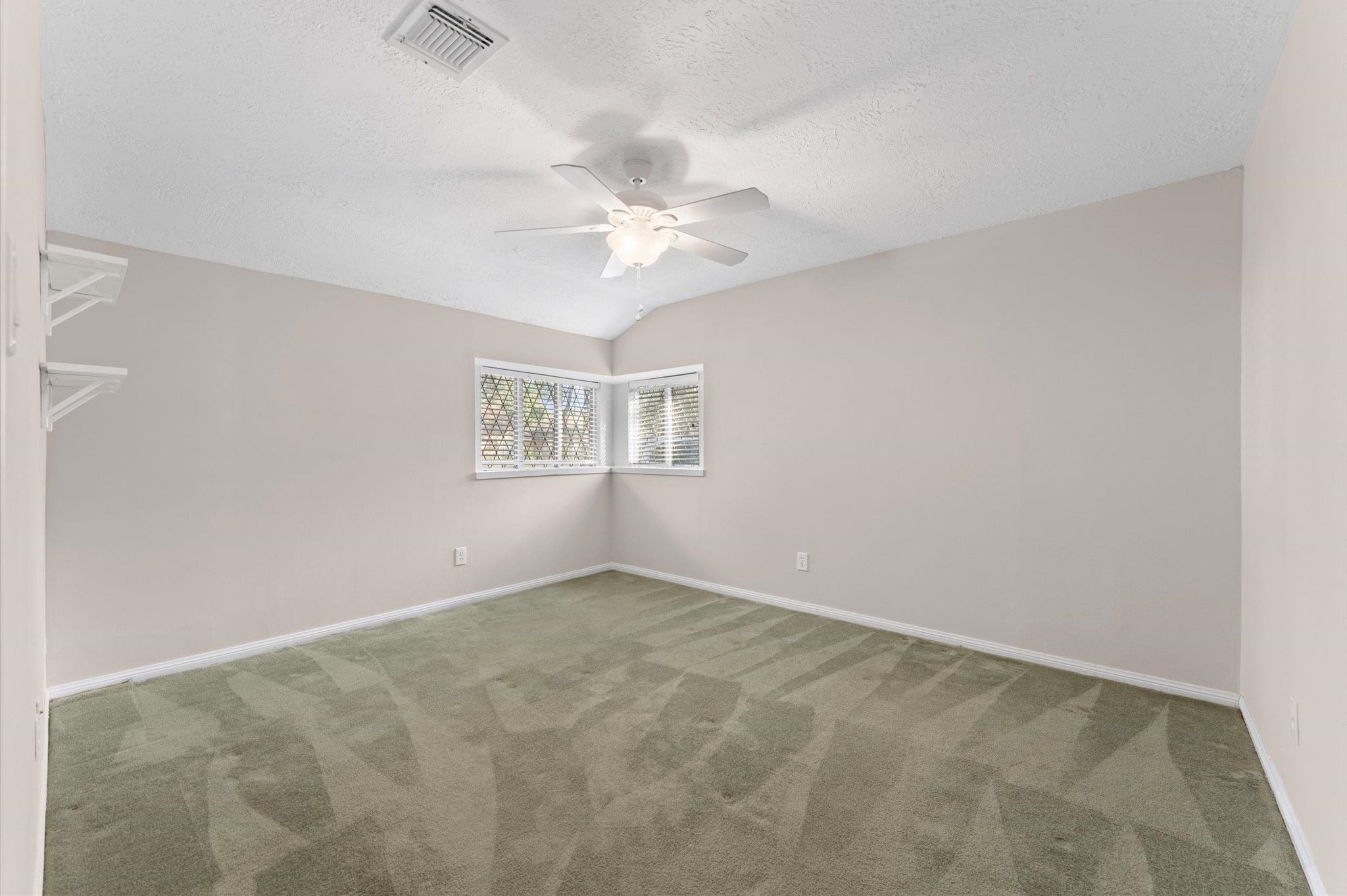 19415 Craigchester Lane Spring, TX 77388 - Photo 15 of 31 an empty room with windows and fan