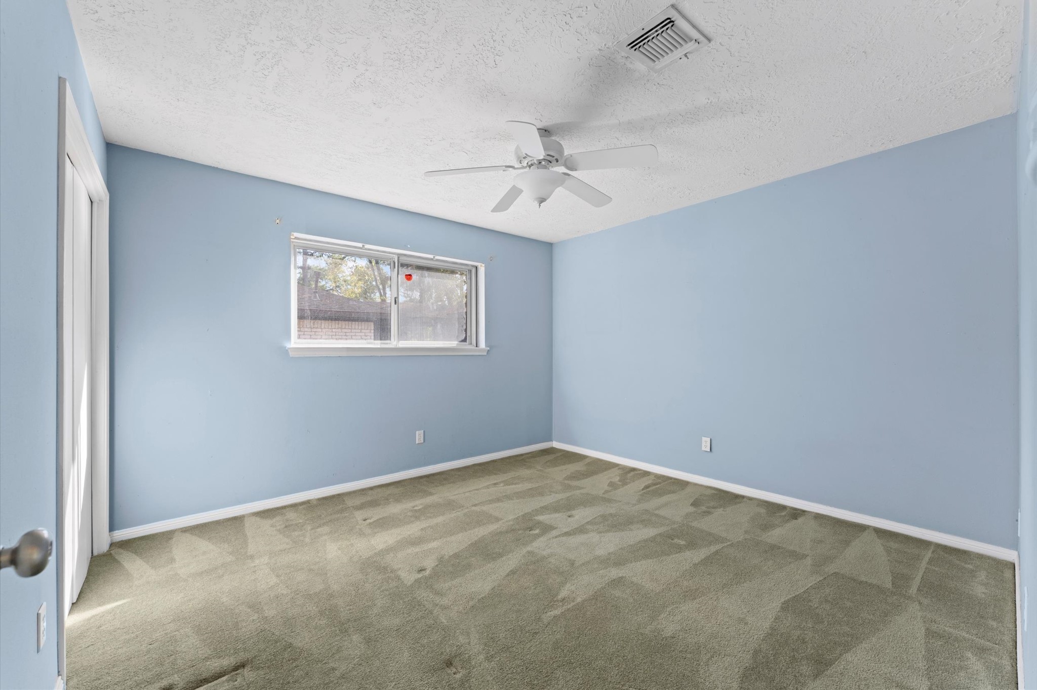 19415 Craigchester Lane Spring, TX 77388 - Photo 17 of 31 an empty room with windows and ceiling fan
