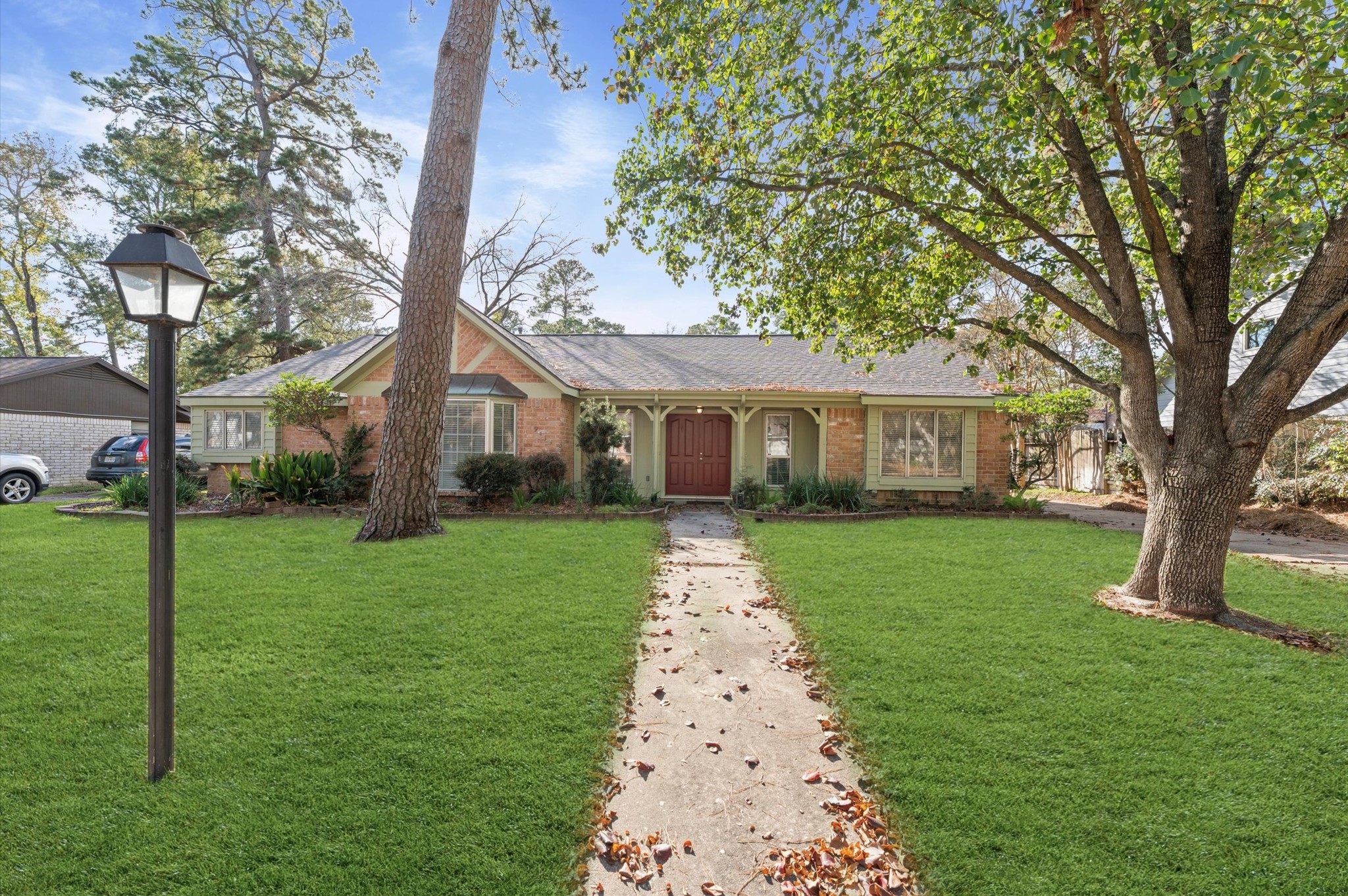 19415 Craigchester Lane Spring, TX 77388 - Photo 2 of 31 a front view of a house with a yard and garden