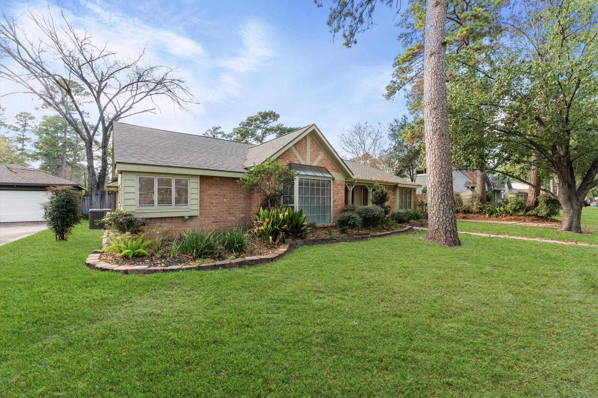 19415 Craigchester Lane Spring, TX 77388 - Photo 3 of 31 a front view of a house with a garden and tree