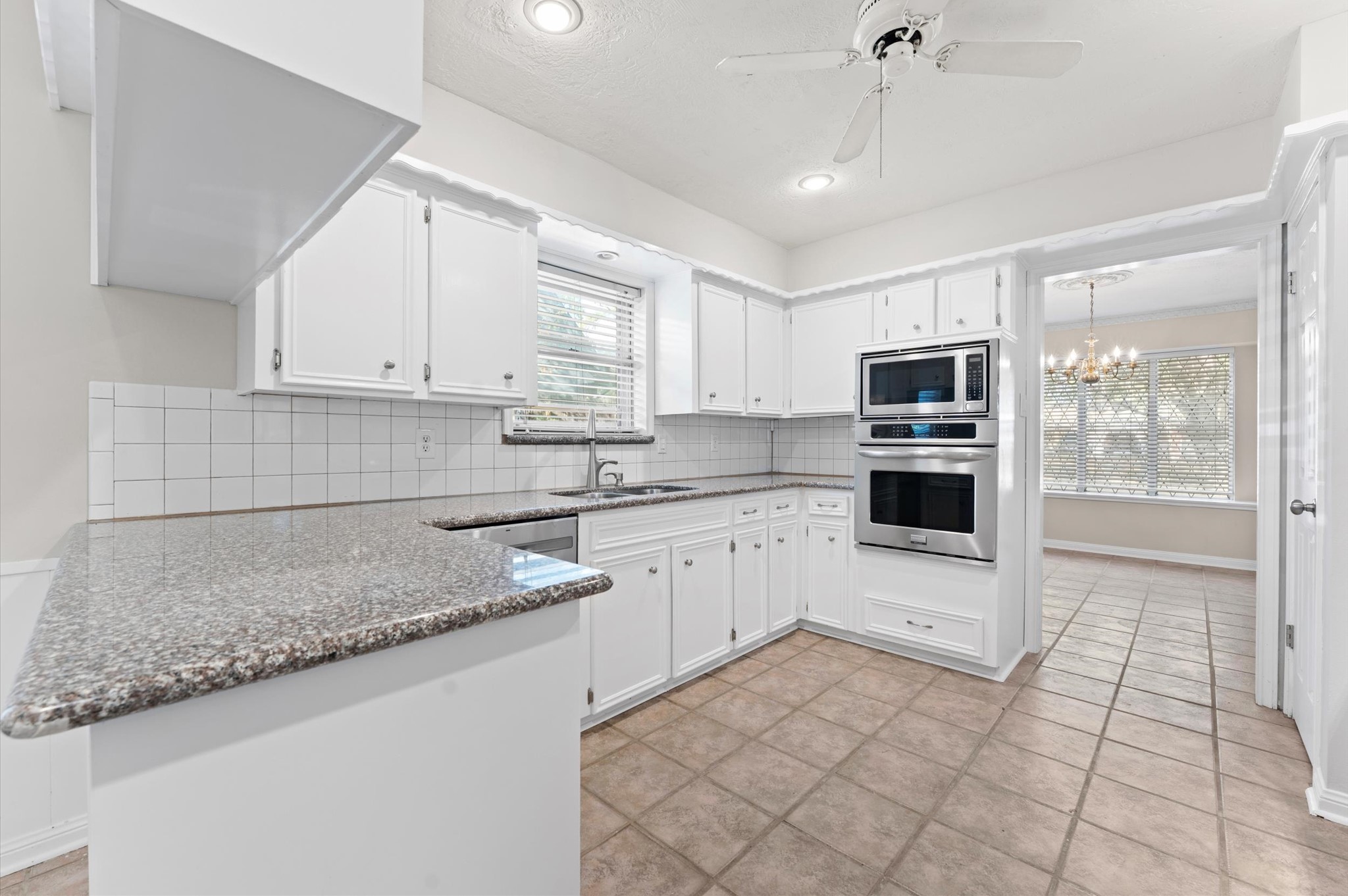 19415 Craigchester Lane Spring, TX 77388 - Photo 10 of 31 a kitchen with a sink window and cabinets
