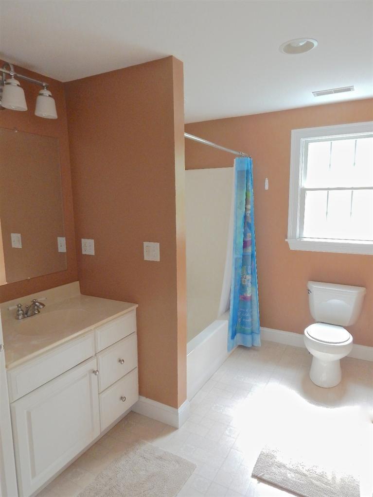 367 Service Road Sandwich, MA 02537 - Photo 27 of 34 a bathroom with a sink a toilet and a window