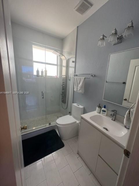 2530 Southwest 153rd Pass Miami, FL 33185 - Photo 6 of 8 a bathroom with a sink a toilet and shower