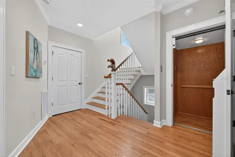 a kitchen with a dining table chairs and sink