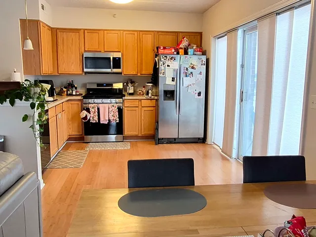 a kitchen with stainless steel appliances a microwave a stove and a refrigerator