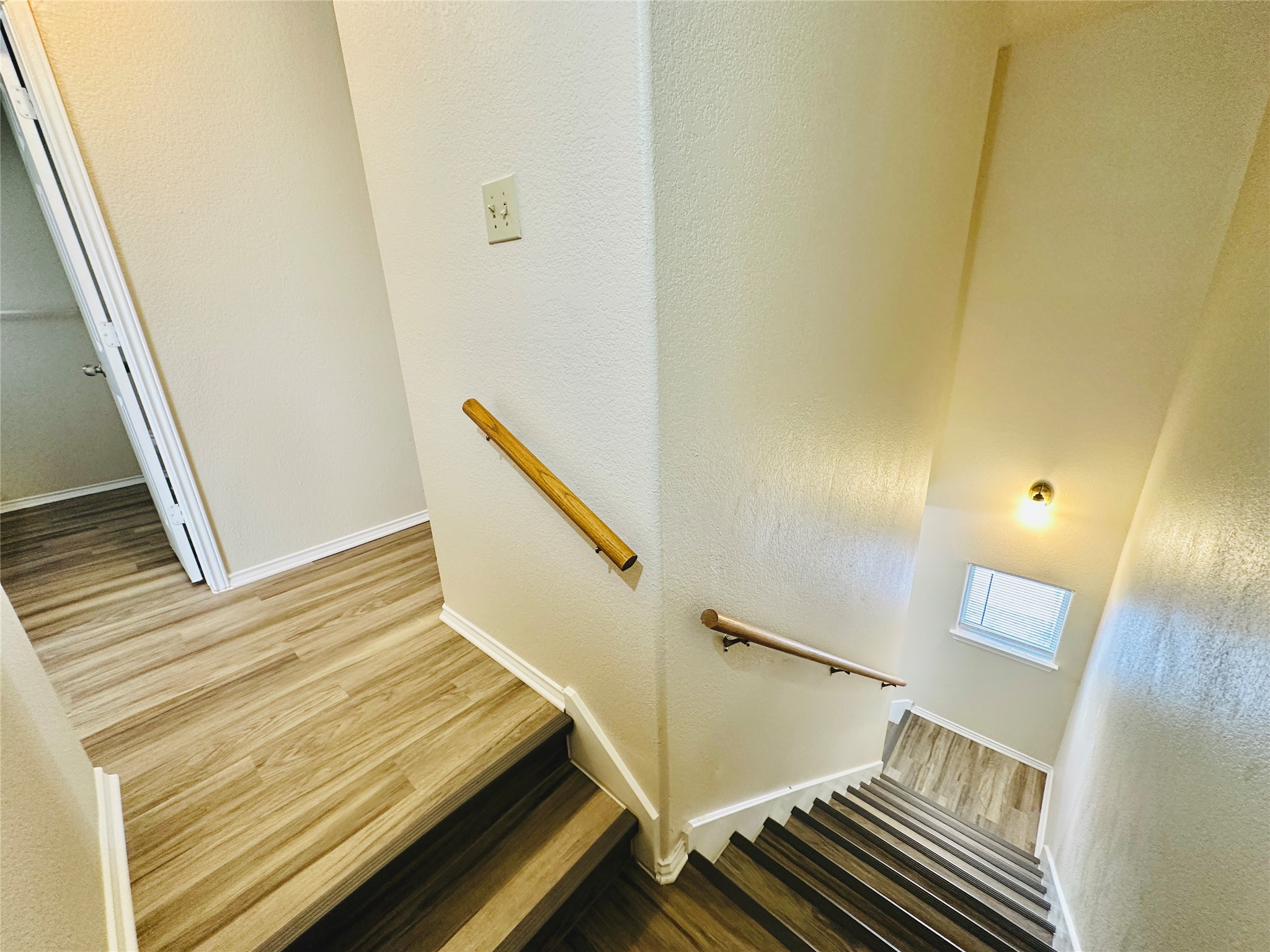 8814 Schick Road, Unit C Austin, TX 78729 - Photo 19 of 35 A well-lit staircase connects levels with durable wood-look flooring.