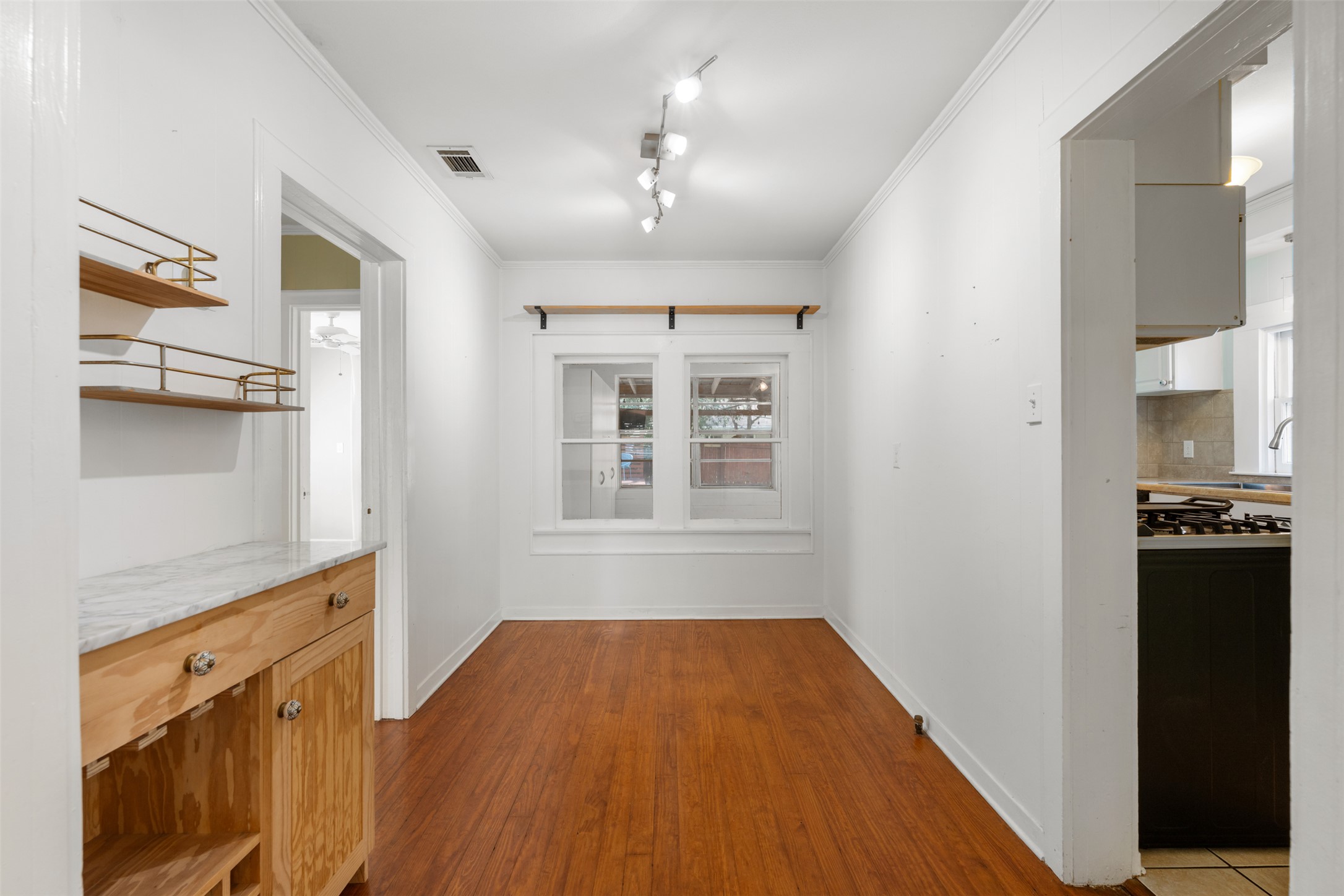 1218 South Myrtle Street Georgetown, TX 78626 - Photo 14 of 37 Dining area featuring ornamental molding, track lighting, and dark wood finished floors