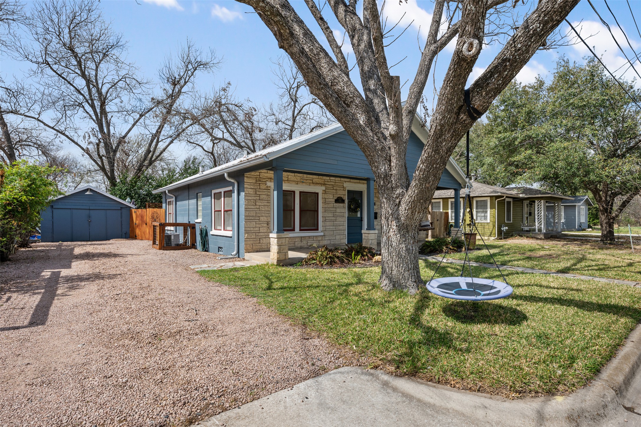 1218 South Myrtle Street Georgetown, TX 78626 - Photo 2 of 37 View of front of house with stone siding, an outbuilding, a detached garage, and driveway