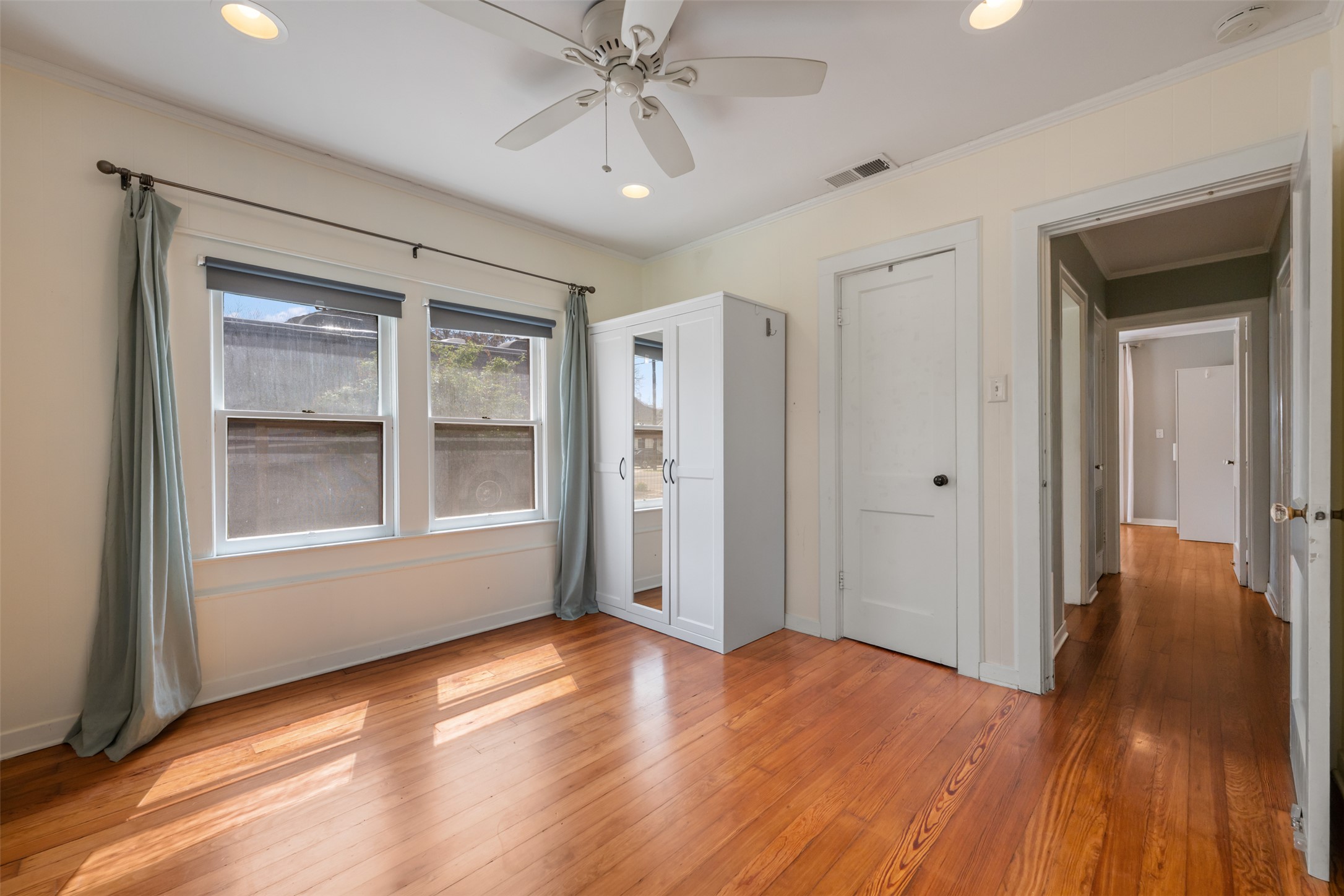 1218 South Myrtle Street Georgetown, TX 78626 - Photo 24 of 37 Primary bedroom featuring light wood finished floors, a ceiling fan, access to outside, recessed lighting, and crown molding