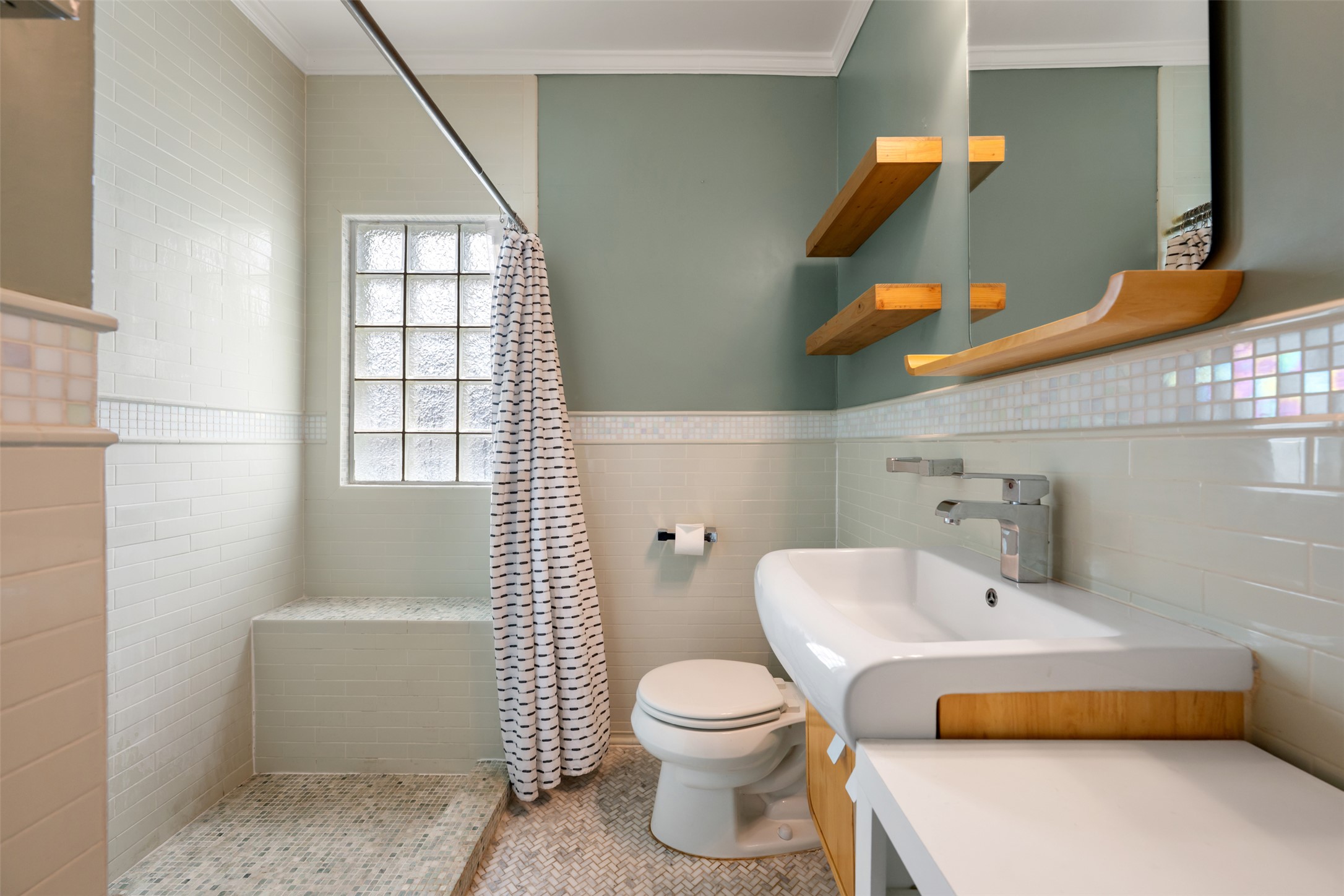 1218 South Myrtle Street Georgetown, TX 78626 - Photo 29 of 37 Bathroom with crown molding, a shower stall, wainscoting, tile walls, and light tile patterned flooring