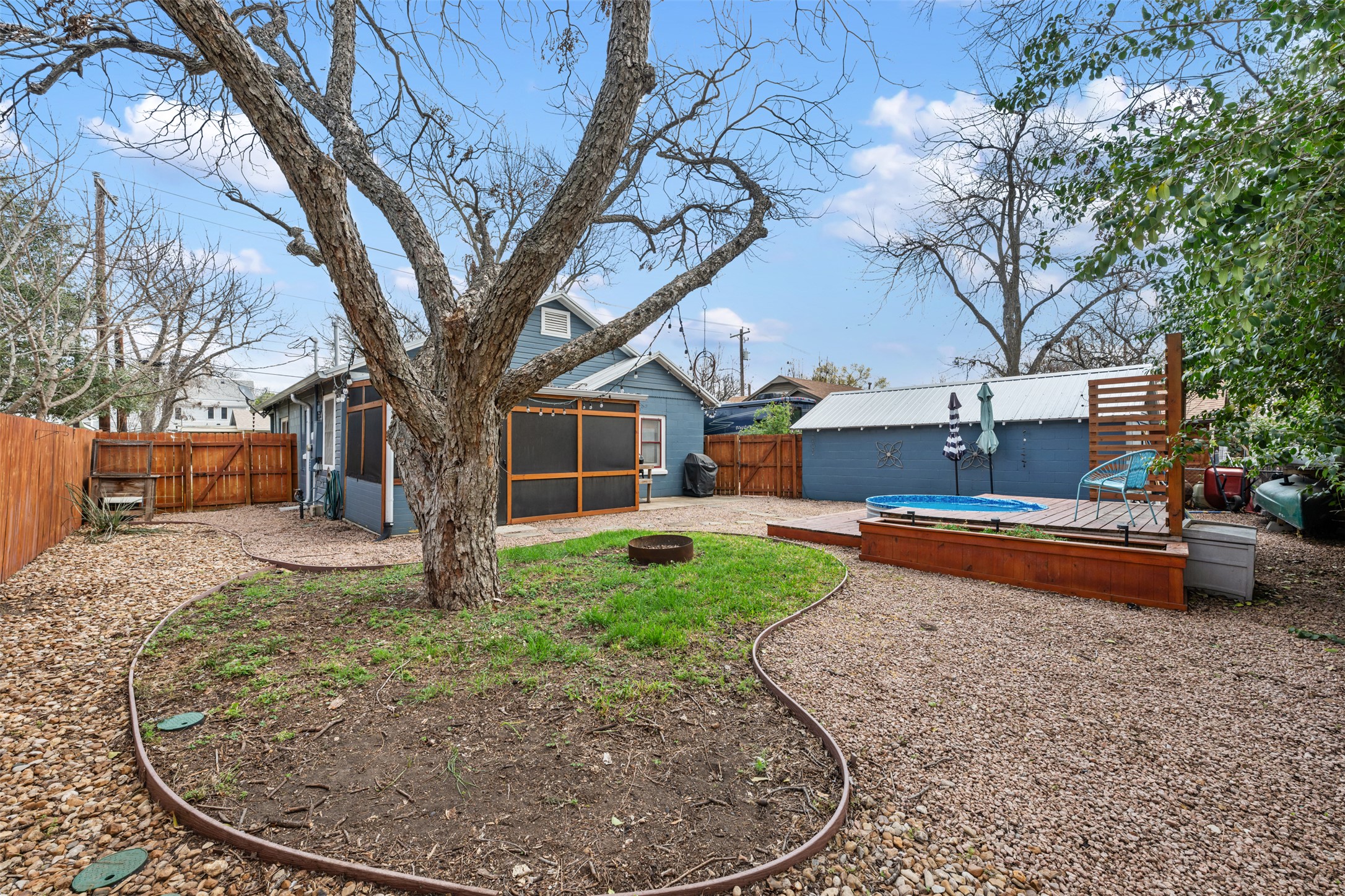 1218 South Myrtle Street Georgetown, TX 78626 - Photo 35 of 37 Fenced backyard with a deck, a sunroom, and a hot tub