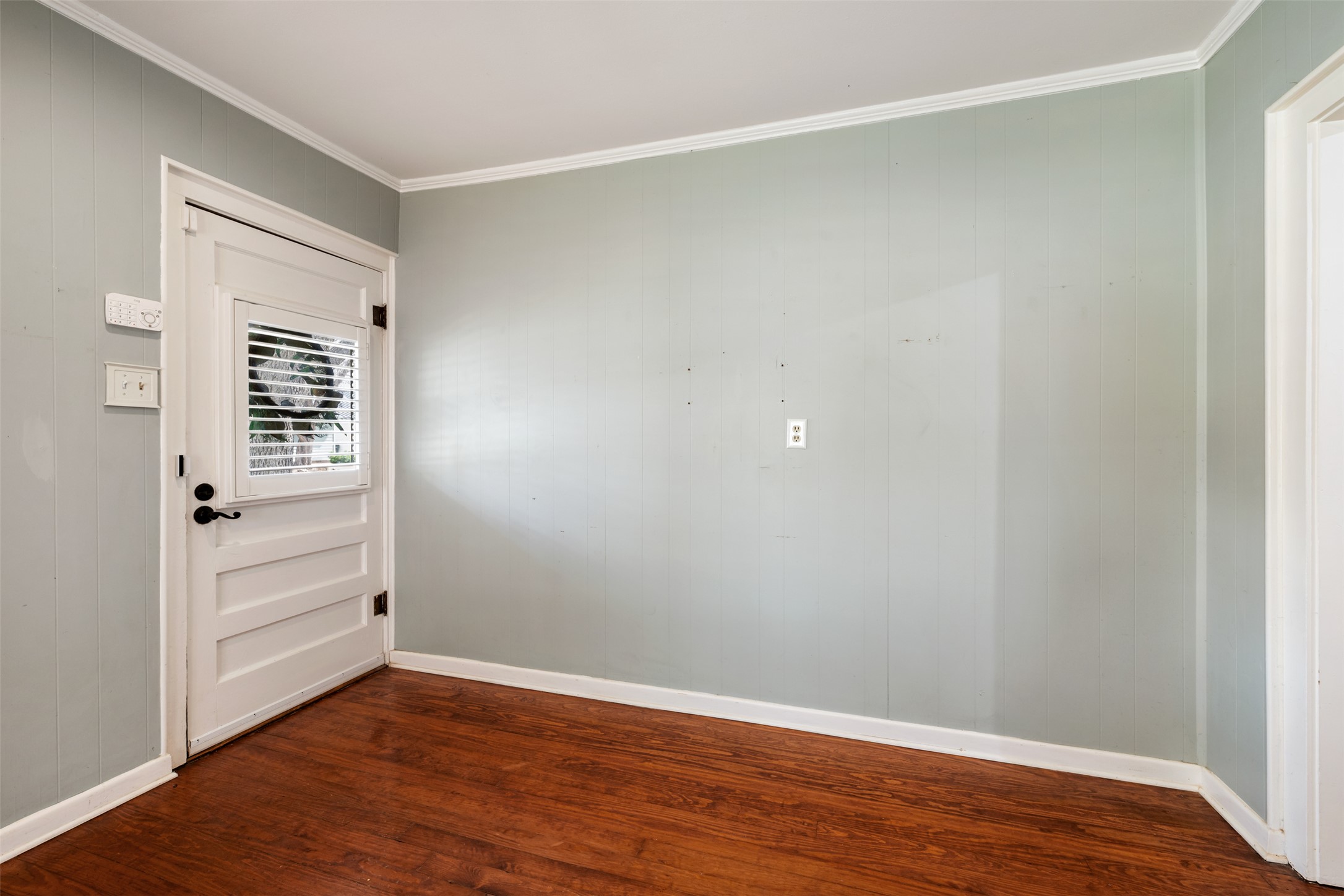 1218 South Myrtle Street Georgetown, TX 78626 - Photo 8 of 37 Doorway to outside featuring wood finished floors, crown molding, and wooden walls